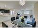 Modern dining room with glass table and chairs, open to living room at 752 Drammatico Pl, Henderson, NV 89011