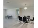 Modern dining room with glass table and black chairs at 752 Drammatico Pl, Henderson, NV 89011