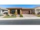 One-story home with brown garage door and stone accents at 752 Drammatico Pl, Henderson, NV 89011