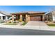 Modern single story home with brown garage door and landscaping at 752 Drammatico Pl, Henderson, NV 89011