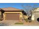 Brown garage and walkway leading to the house entrance at 752 Drammatico Pl, Henderson, NV 89011