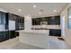 Modern kitchen with dark cabinets, white quartz countertops and tile backsplash at 752 Drammatico Pl, Henderson, NV 89011