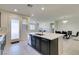 Modern kitchen with island, stainless steel appliances, and white quartz countertops at 752 Drammatico Pl, Henderson, NV 89011