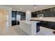 Modern kitchen with dark cabinets, white quartz countertops and tile backsplash at 752 Drammatico Pl, Henderson, NV 89011