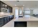 Modern kitchen with island, stainless steel appliances, and white quartz countertops at 752 Drammatico Pl, Henderson, NV 89011