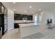 Modern kitchen with dark cabinets, white quartz countertops and tile backsplash at 752 Drammatico Pl, Henderson, NV 89011