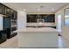 Modern kitchen with dark cabinets, white quartz countertops and tile backsplash at 752 Drammatico Pl, Henderson, NV 89011