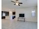 Open living room with tile floors and a view into the kitchen at 752 Drammatico Pl, Henderson, NV 89011