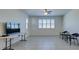 Living room with tile floors, a large window, and seating area at 752 Drammatico Pl, Henderson, NV 89011