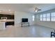 Living room with kitchen views, tile floors and a large TV at 752 Drammatico Pl, Henderson, NV 89011