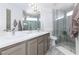 Modern bathroom boasts double vanity, large shower, and stylish tile at 9542 Gainey Ranch Ave, Las Vegas, NV 89147