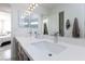 Double vanity bathroom with quartz countertop and chrome fixtures at 9542 Gainey Ranch Ave, Las Vegas, NV 89147