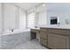 Elegant bathroom featuring a soaking tub and double vanity at 9542 Gainey Ranch Ave, Las Vegas, NV 89147