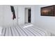 Bright bedroom with striped bedding and ensuite bathroom access at 9542 Gainey Ranch Ave, Las Vegas, NV 89147