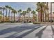 Gated community entrance with palm trees and landscaping at 9542 Gainey Ranch Ave, Las Vegas, NV 89147