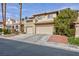 Two-story house with three-car garage and desert landscaping at 9542 Gainey Ranch Ave, Las Vegas, NV 89147