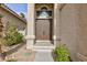 Double front doors with arched window and landscaping at 9542 Gainey Ranch Ave, Las Vegas, NV 89147