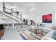 Living room with a curved staircase, home bar and sectional sofa at 9542 Gainey Ranch Ave, Las Vegas, NV 89147