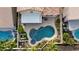 Relaxing backyard oasis featuring a freeform pool, spa, and patio at 9542 Gainey Ranch Ave, Las Vegas, NV 89147