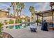 Relaxing pool area with covered patio and grill at 9542 Gainey Ranch Ave, Las Vegas, NV 89147