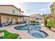 Large kidney shaped pool with spa and covered patio at 9542 Gainey Ranch Ave, Las Vegas, NV 89147