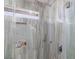 Shower with marble-like wall tiles and built-in storage niche at 9542 Gainey Ranch Ave, Las Vegas, NV 89147