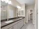 Elegant bathroom featuring double sinks and a large mirror at 9911 Spinel Pl, Las Vegas, NV 89143