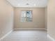 Bright and airy bedroom with neutral walls and tile flooring at 9911 Spinel Pl, Las Vegas, NV 89143