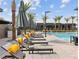 Modern pool deck with plenty of lounge chairs for sunbathing at 9911 Spinel Pl, Las Vegas, NV 89143