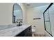 Modern bathroom with marble countertop and arched mirror at 10173 Grants Arbor Rd, Las Vegas, NV 89183