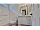 Updated bathroom with white vanity, tub, and grab bars at 10173 Grants Arbor Rd, Las Vegas, NV 89183