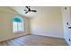 Bedroom with arched window, wood-look floors, and ceiling fan at 10173 Grants Arbor Rd, Las Vegas, NV 89183