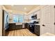 Modern kitchen with stainless steel appliances and a farmhouse sink at 10173 Grants Arbor Rd, Las Vegas, NV 89183