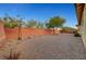 Large backyard with gravel and brick wall at 10290 Hawks Wing St, Las Vegas, NV 89178