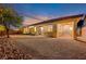 Landscaped backyard with gravel and patio at 10290 Hawks Wing St, Las Vegas, NV 89178