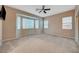 Bright bedroom with bay window, ceiling fan, and carpeting at 10290 Hawks Wing St, Las Vegas, NV 89178