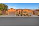 Two-story house with taupe colored exterior and three car garage at 10290 Hawks Wing St, Las Vegas, NV 89178