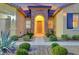 Inviting entryway with a stone arch and well-manicured landscaping at 10290 Hawks Wing St, Las Vegas, NV 89178