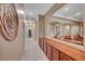 Elegant hallway with wood cabinetry and views into the living room at 10290 Hawks Wing St, Las Vegas, NV 89178