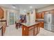 Kitchen features granite island, stainless steel refrigerator, and hardwood cabinets at 10290 Hawks Wing St, Las Vegas, NV 89178