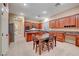 Modern kitchen with wood cabinets, granite countertops and island at 10290 Hawks Wing St, Las Vegas, NV 89178