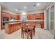 Well-equipped kitchen featuring wood cabinets, granite counters and breakfast area at 10290 Hawks Wing St, Las Vegas, NV 89178