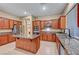 Modern kitchen with granite counters, stainless steel appliances, and hardwood cabinets at 10290 Hawks Wing St, Las Vegas, NV 89178