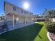 Spacious backyard with covered patio, artificial turf, and putting green at 10488 Beckaville Ave, Las Vegas, NV 89129