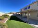 Backyard with artificial turf, covered patio, and mountain views at 10488 Beckaville Ave, Las Vegas, NV 89129