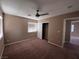 Spacious bedroom with carpeted floor, ceiling fan, and ample closet space at 10488 Beckaville Ave, Las Vegas, NV 89129