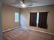 Spacious carpeted bedroom with ceiling fan and large windows at 10488 Beckaville Ave, Las Vegas, NV 89129