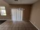 Bright dining room with tile floors and sliding glass door at 10488 Beckaville Ave, Las Vegas, NV 89129