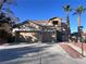 Two-story house with a two-car garage and desert landscaping at 10488 Beckaville Ave, Las Vegas, NV 89129