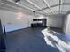 Spacious garage featuring epoxy flooring and ample storage solutions at 10488 Beckaville Ave, Las Vegas, NV 89129